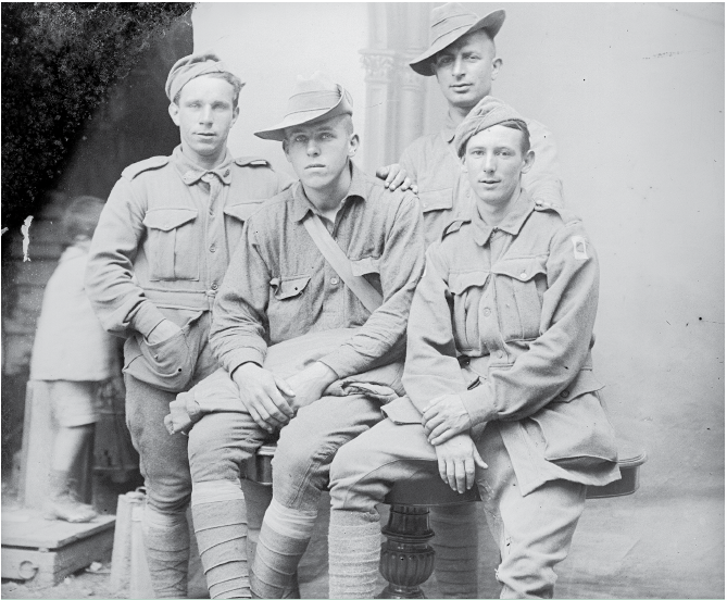 Australians in France quickly made friends with the newly arrived American troops. Here, in a group of men resting at Vignacourt in 1918, two Australians have swapped headwear with two Americans before facing the camera.